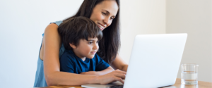 little boy and mom working on laptop together