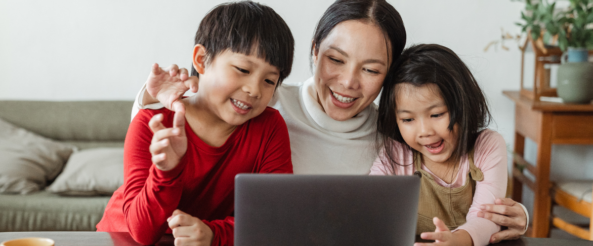 mom with kids learning on laptop